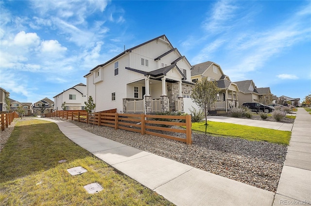 10912 Memphis Ct, Commerce City, CO 80022 - view of front of home featuring a residential view, board and batten siding, driveway, a porch, and a garage