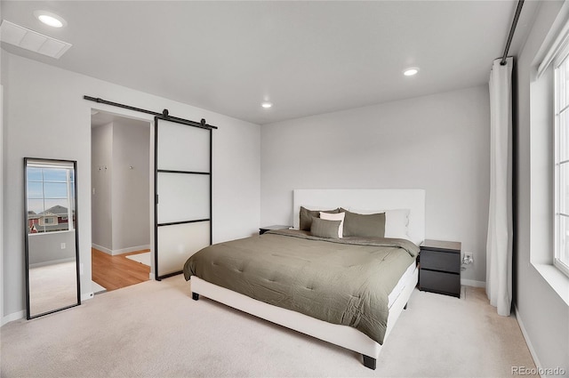 10912 Memphis Ct, Commerce City, CO 80022 - bedroom with carpet, a barn door, multiple windows, baseboards, and recessed lighting
