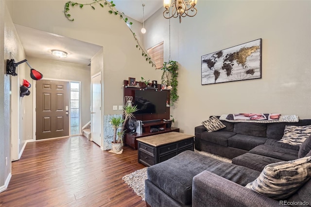 living room featuring a high ceiling, dark hardwood / wood-style floors, and a notable chandelier