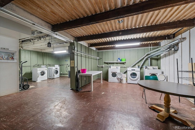 shared laundry area featuring tile patterned floors and washing machine and dryer