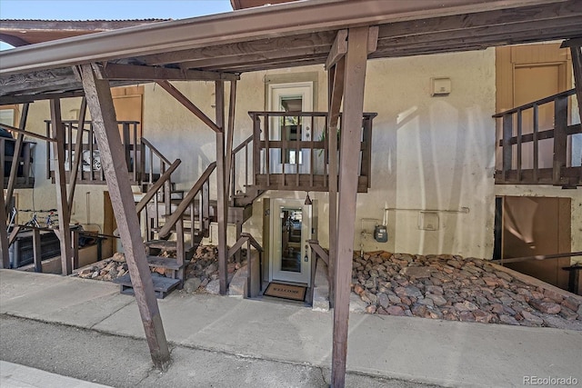 entrance to property featuring stucco siding