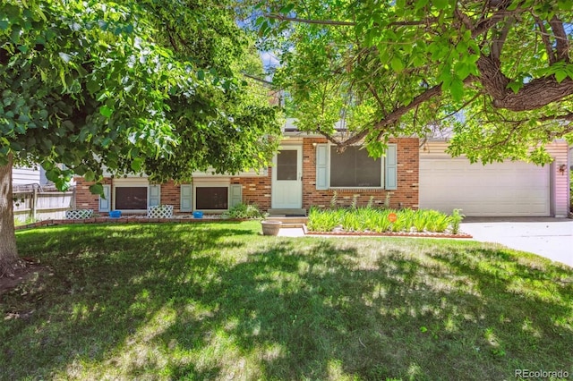 2516 S Cimarron St, Aurora, CO 80014 - view of property hidden behind natural elements featuring brick siding, concrete driveway, a front yard, and an attached garage