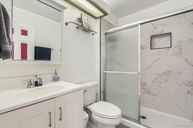 bathroom with vanity, toilet, and walk in shower