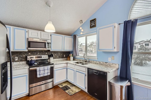 kitchen with stainless steel appliances, sink, and white cabinets