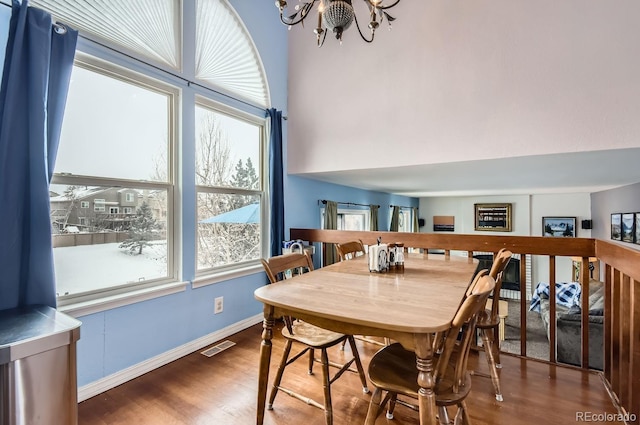 dining room featuring wood-type flooring and a chandelier