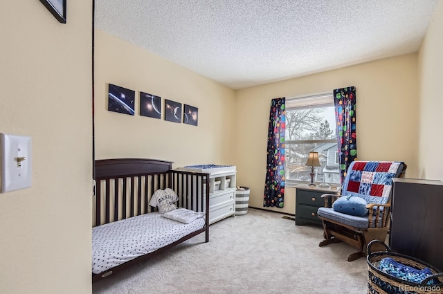 bedroom featuring light colored carpet and a textured ceiling