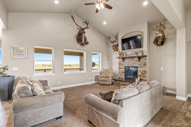45425 Wolf Creek Dr, Bennett, CO 80102 - living room with a ceiling fan, high vaulted ceiling, recessed lighting, a fireplace, and carpet flooring