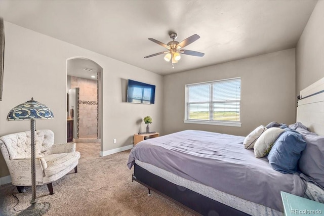 45425 Wolf Creek Dr, Bennett, CO 80102 - carpeted bedroom featuring arched walkways, ensuite bath, and a ceiling fan