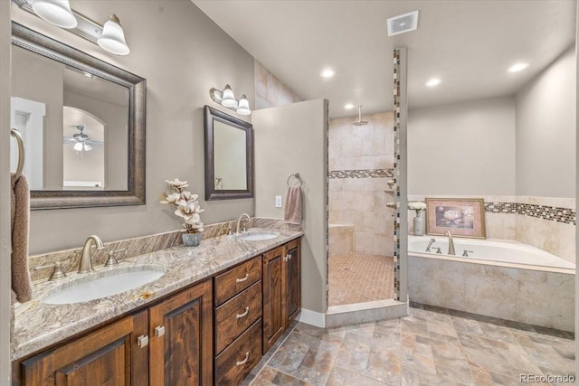 45425 Wolf Creek Dr, Bennett, CO 80102 - full bathroom featuring a garden tub, a tile shower, double vanity, stone tile floors, and recessed lighting