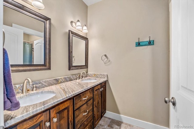 45425 Wolf Creek Dr, Bennett, CO 80102 - bathroom featuring double vanity and stone finish flooring