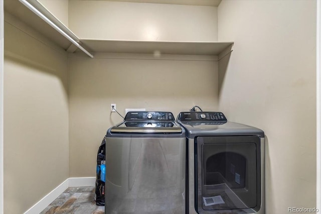 45425 Wolf Creek Dr, Bennett, CO 80102 - laundry area featuring washer and dryer and stone finish flooring