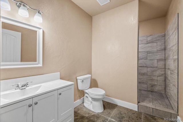 45425 Wolf Creek Dr, Bennett, CO 80102 - bathroom featuring vanity, tiled shower, and tile patterned flooring