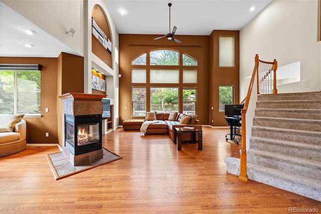 6427 S Tibet St, Aurora, CO 80016 - living area with healthy amount of natural light, ceiling fan, wood finished floors, stairway, and recessed lighting