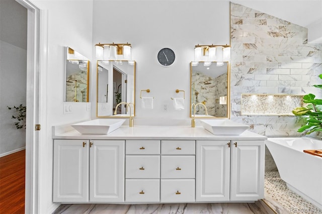 6427 S Tibet St, Aurora, CO 80016 - full bathroom with a freestanding tub, double vanity, and wood finished floors