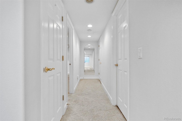 6427 S Tibet St, Aurora, CO 80016 - hallway featuring light colored carpet, recessed lighting, and arched walkways