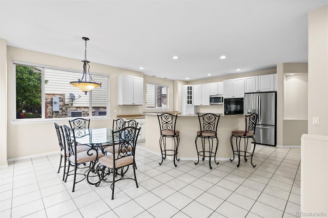 6427 S Tibet St, Aurora, CO 80016 - dining space with light tile patterned floors and recessed lighting