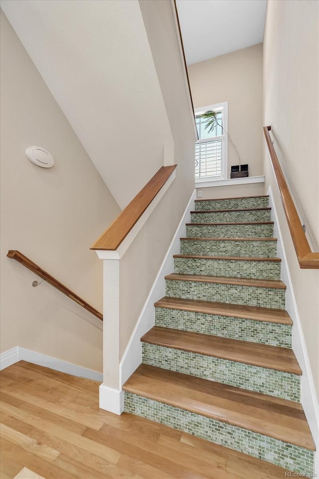 stairs with baseboards and wood finished floors