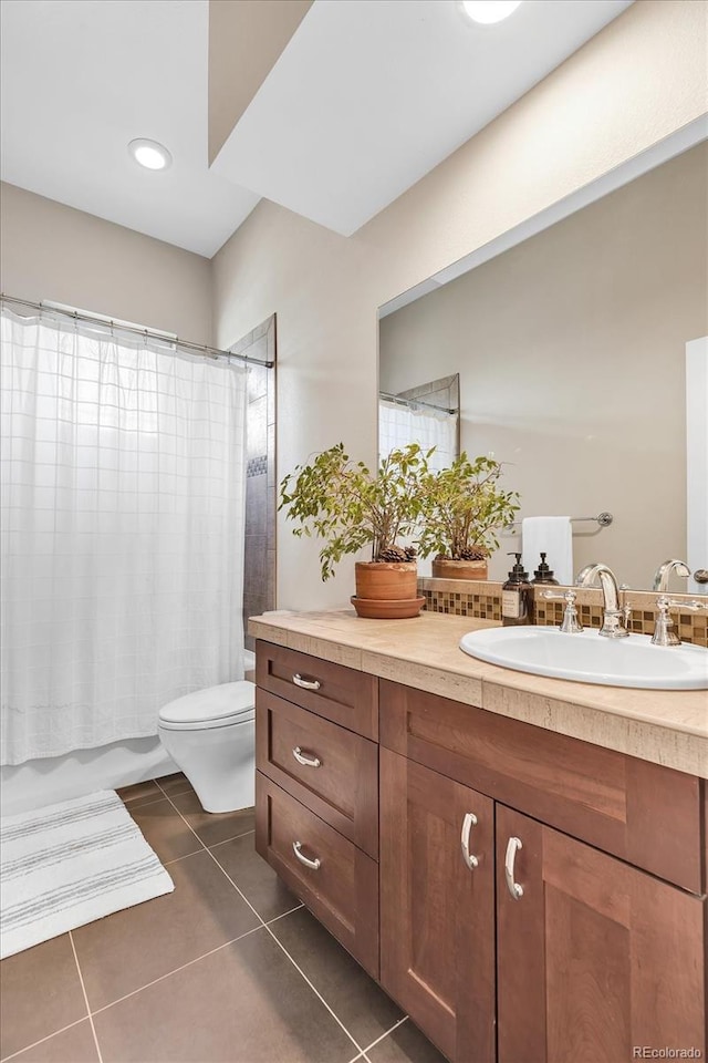 bathroom with toilet, tile patterned floors, vanity, and shower / bath combination with curtain