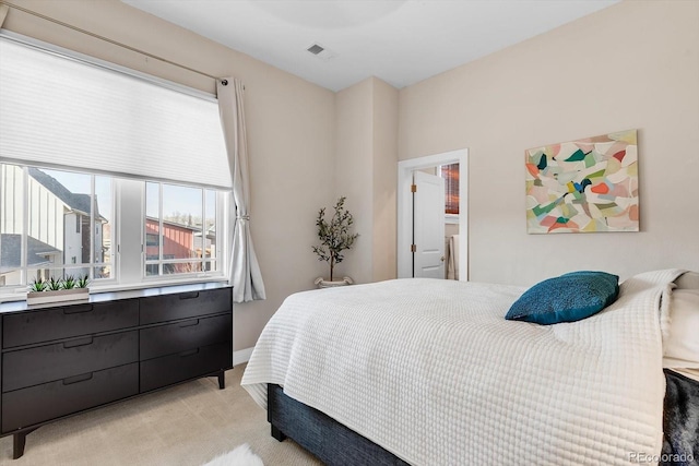 bedroom featuring light carpet and visible vents