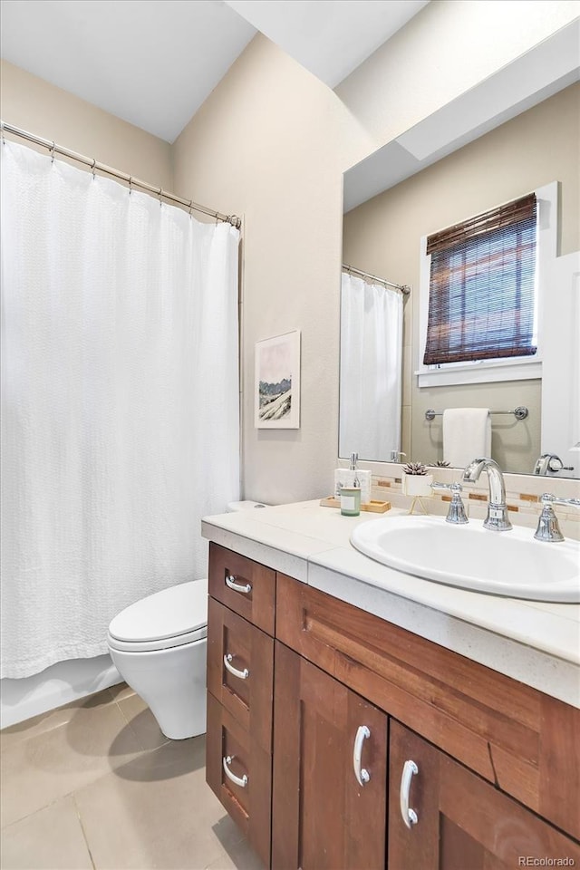 bathroom with tile patterned floors, toilet, and vanity