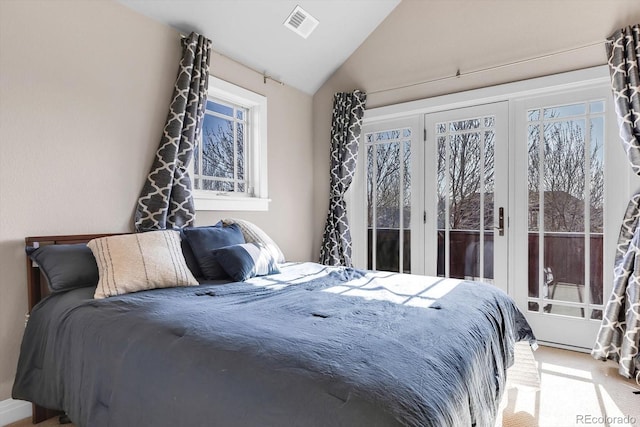 bedroom featuring multiple windows, visible vents, light colored carpet, and vaulted ceiling