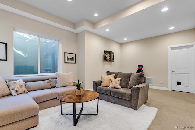 living area featuring light colored carpet, visible vents, baseboards, and recessed lighting