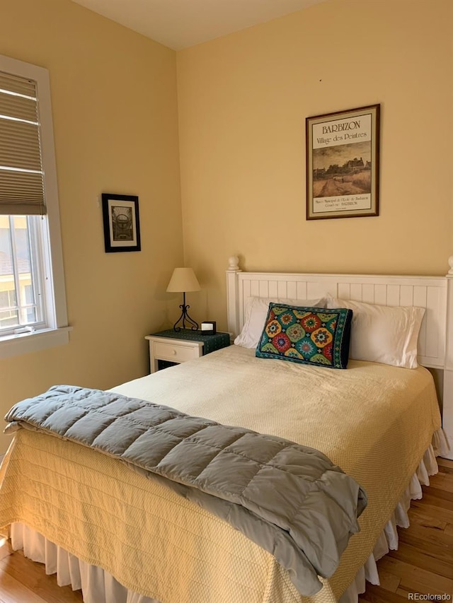 bedroom with wood finished floors