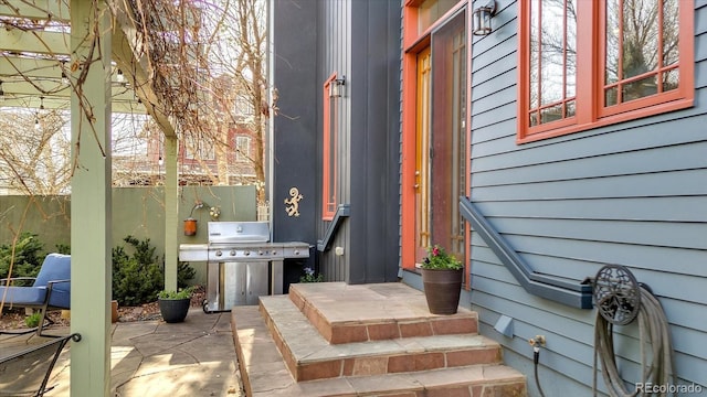 doorway to property featuring fence