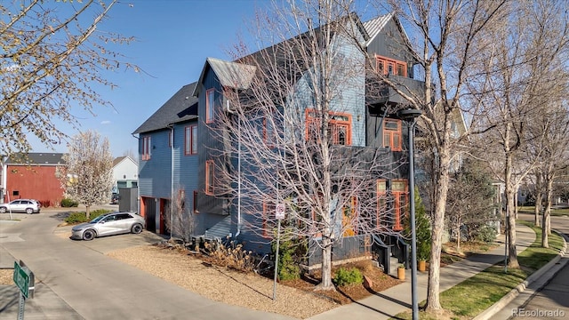 view of home's exterior featuring concrete driveway