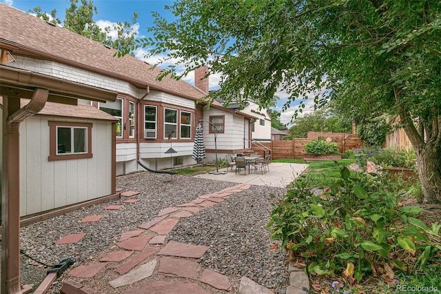 view of yard with entry steps, a patio, and fence