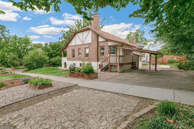 view of front of property featuring driveway and a chimney