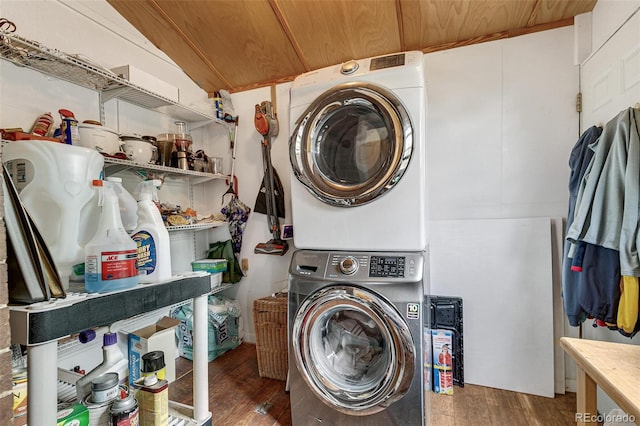 clothes washing area with wood ceiling, laundry area, stacked washer and dryer, and wood finished floors