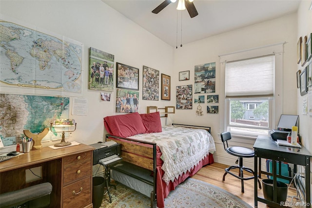 bedroom with light wood-type flooring, baseboards, and ceiling fan