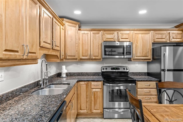 4400 Lodgepole Cir Unit 101, Silverthorne, CO 80498 - kitchen featuring appliances with stainless steel finishes, a sink, recessed lighting, dark stone countertops, and ornamental molding