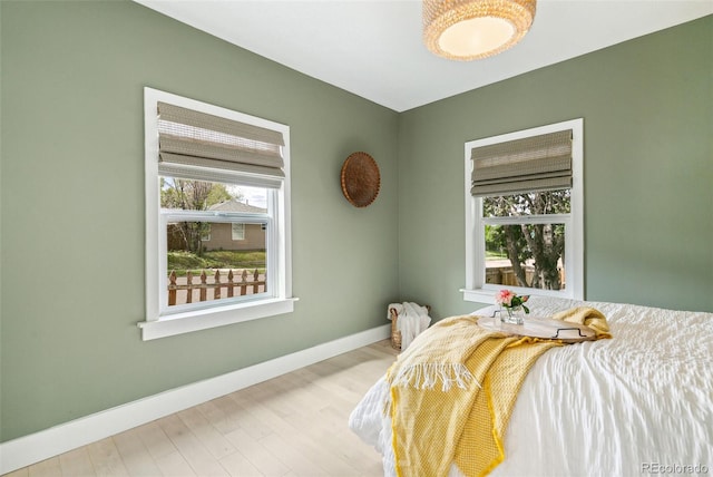3625 W 9th Ave, Denver, CO 80204 - bedroom with multiple windows, baseboards, and wood finished floors