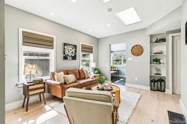 3625 W 9th Ave, Denver, CO 80204 - living room featuring a skylight, light wood finished floors, recessed lighting, and baseboards
