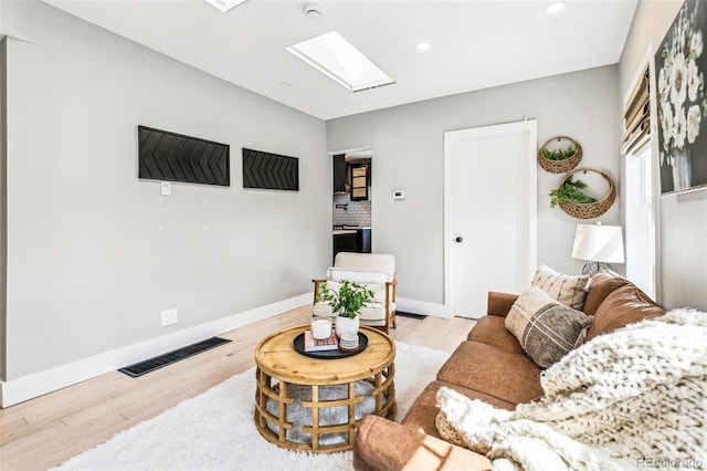3625 W 9th Ave, Denver, CO 80204 - living area featuring a skylight, wood finished floors, recessed lighting, and baseboards
