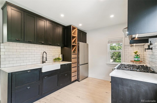 3625 W 9th Ave, Denver, CO 80204 - kitchen with a sink, freestanding refrigerator, light wood-style flooring, tasteful backsplash, and recessed lighting