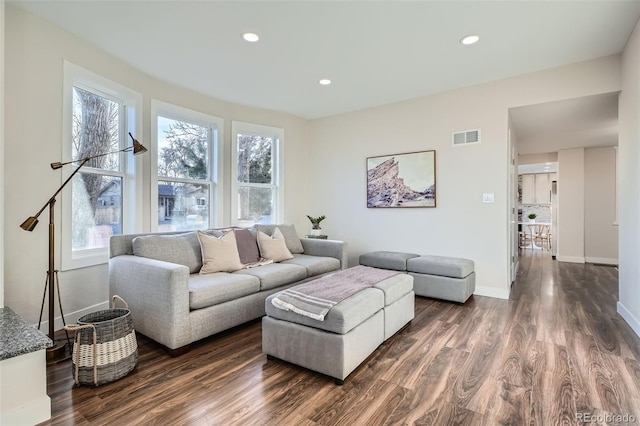 living room with plenty of natural light, recessed lighting, visible vents, and dark wood-style flooring