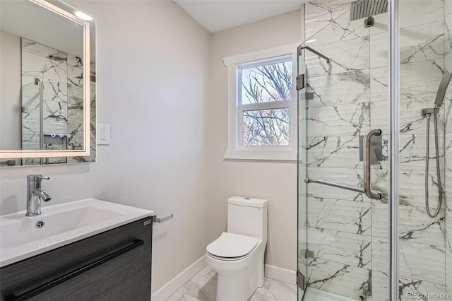 full bathroom featuring toilet, marble finish floor, a marble finish shower, baseboards, and vanity