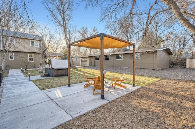 exterior space featuring a patio area, an outdoor fire pit, a hot tub, and fence