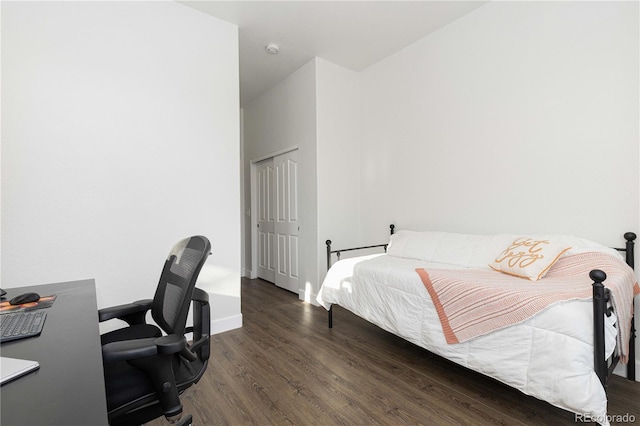 bedroom with a closet and dark wood-type flooring