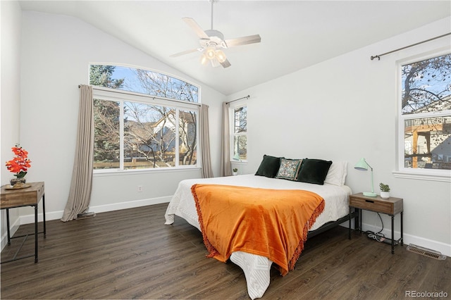 bedroom featuring dark hardwood / wood-style floors, vaulted ceiling, and ceiling fan