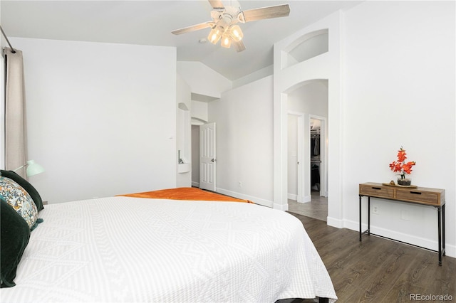 bedroom with dark hardwood / wood-style floors, vaulted ceiling, and ceiling fan