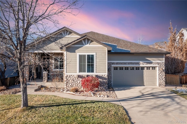 view of front of property with a yard and a garage