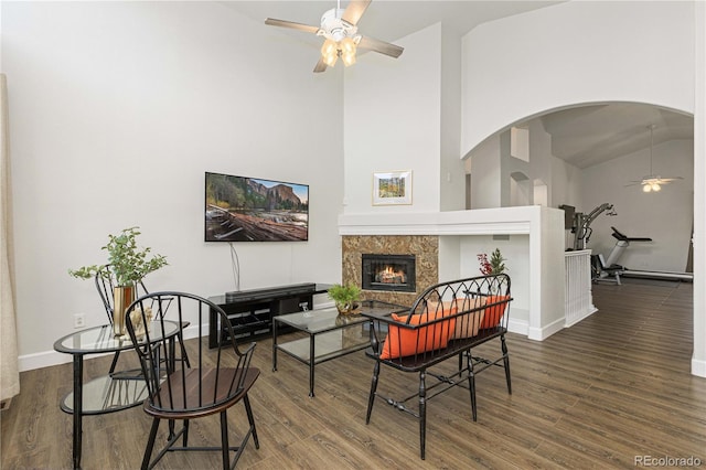 sitting room featuring hardwood / wood-style flooring, ceiling fan, and a high ceiling