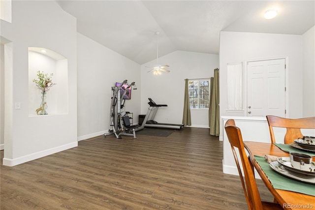 workout room featuring ceiling fan, dark hardwood / wood-style floors, and vaulted ceiling