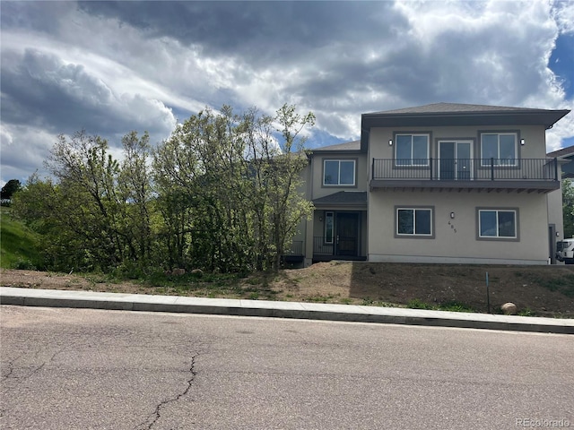 485 Cardiff Cir, Colorado Springs, CO 80906 - view of front of house featuring a balcony and stucco siding