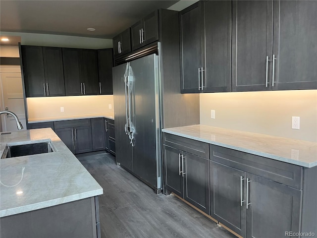 485 Cardiff Cir, Colorado Springs, CO 80906 - kitchen featuring high end refrigerator, a sink, dark wood-style flooring, recessed lighting, and light stone counters