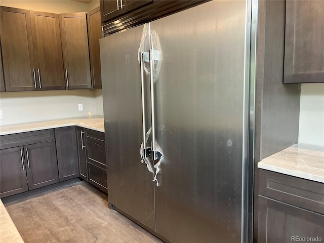 485 Cardiff Cir, Colorado Springs, CO 80906 - kitchen with high end refrigerator, light countertops, and light wood-style floors